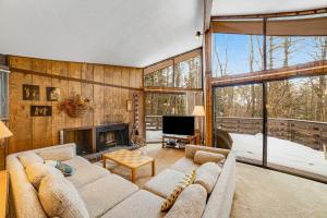 a living room with a couch and a fireplace at Dwight Road Getaway in Quechee