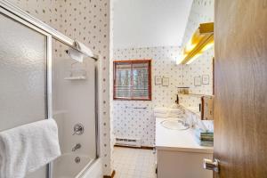 a bathroom with a tub and a sink and a shower at Dwight Road Getaway in Quechee +59 photos