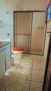 a bathroom with a shower with a toilet and a sink at Pousada Litoral Norte Caragua in Caraguatatuba
