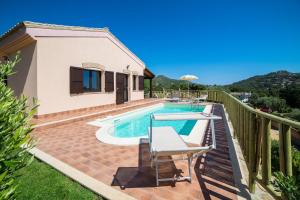 a villa with a swimming pool and a house at Villa Ara in Torre delle Stelle