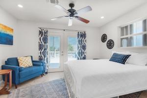 a bedroom with a bed and a blue chair at Makarios Beach Blu in Navarre