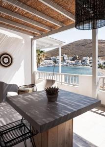 a dining room with a table and a view of the water at Cactus Suites Kythnos in Mérikhas