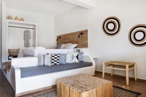 a bedroom with a bed and a table at Cactus Suites Kythnos in Mérikhas