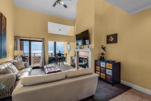 a living room with a couch and a table at Palm Beach Club 3-235 in Pensacola Beach