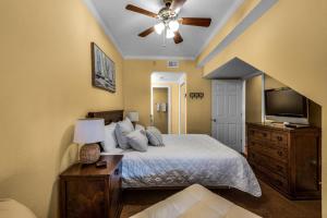 a bedroom with a bed and a ceiling fan at Palm Beach Club 3-235 in Pensacola Beach +59 photos
