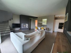 a living room with a white couch and a table at Villa Maya in Mergozzo