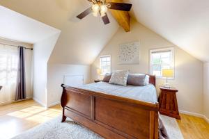 a bedroom with a bed and a ceiling fan at West Asheville Loft in Asheville