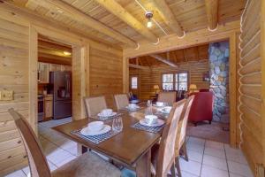 a dining room with a table and chairs in a cabin at Interlochen Cabin with Fireplace - Near State Park! in Interlochen
