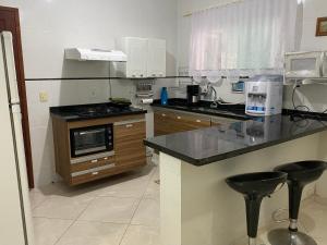 a kitchen with a stove and a counter top at Casa aconchegante para lazer e descanso Araruama in Araruama
