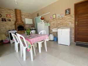 kuchnia ze stołem, krzesłami i kominkiem w obiekcie Casa aconchegante para lazer e descanso Araruama w mieście Araruama