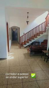 a room with a staircase with a couch and benches at Pousada Litoral Norte Caragua in Caraguatatuba