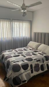 a bedroom with a bed with a cow patterned blanket at Departamento en peatonal Mendoza in Mendoza