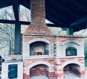 a brick oven with a fire inside of it at Pensiunea La Brazi in Mănăstirea Humorului