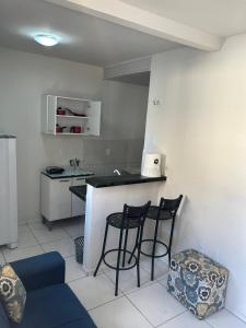 a kitchen with two stools and a counter in a room at Apartamento Premium Grand Luxo in Fortaleza