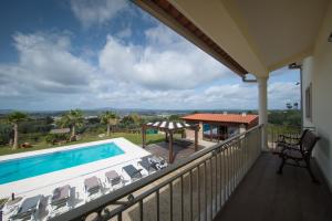 a balcony with a swimming pool and chairs at Quinta dos Silvas - Piscina in Ansião