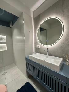 a bathroom with a sink and a mirror at Apartment in Tirana in Tirana