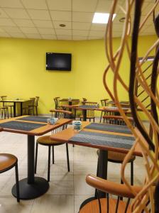 a conference room with tables and chairs and a tv at Hotel Industria in Brescia