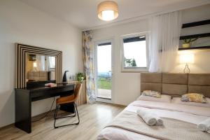 a bedroom with a desk and a bed and a desk at Pensjonat Orle in Krynica Zdrój