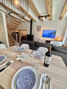 a dining table with a bottle of wine on it at Laura's Haus in Tudela