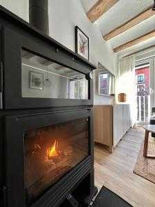 a fireplace in a living room with a fire in it at Laura's Haus in Tudela