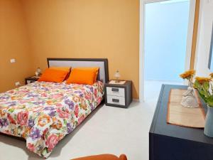 a bedroom with a bed with orange pillows on it at Perla di Mare in Castel di Tusa
