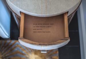 a hat with a poem on it on a shelf at The Norman Tel Aviv in Tel Aviv