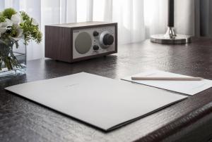 a wooden table with a radio sitting on a table at The Norman Tel Aviv in Tel Aviv