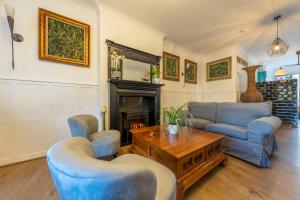 a living room with blue furniture and a fireplace at The Berry Boutique in Bowness-on-Windermere +77 photos