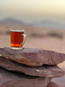 a cup of tea sitting on a rock at Quite bedouin life in Wadi Rum