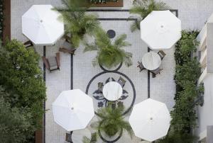 an overhead view of a patio with tables and umbrellas at The Norman Tel Aviv in Tel Aviv