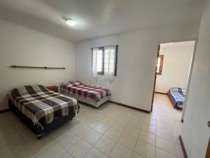 a bedroom with two beds and a door to a room at Casa Storni in Mar del Plata