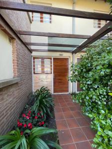 a walkway leading to a garage with a wooden door at Casa Storni in Mar del Plata