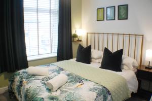a bedroom with a bed with two pillows on it at Townhouse with private parking in York