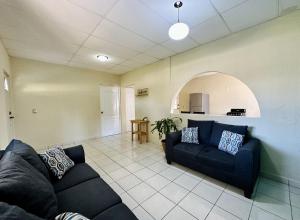 a living room with a couch and a kitchen at Zamá house in Palenque