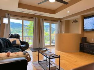 a living room with a couch and a flat screen tv at Hunter Mountain Ski House - A Cozy Retreat by the Slopes in Hunter