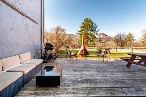 a patio with furniture and a table and chairs at Hunter Mountain Ski House - A Cozy Retreat by the Slopes in Hunter