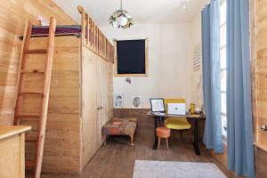 a room with a bunk bed and a desk with a desk at Wanderer Studio, AN OFF GRID MOUNTAIN Guest Studio With Fantastic Views in Glenwood Springs