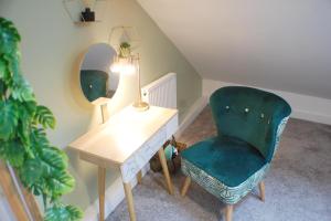 a room with a desk and a chair and a mirror at Townhouse with private parking in York