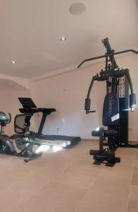 a gym with several tread machines in a room at Amimaya Apartments in Emporeiós