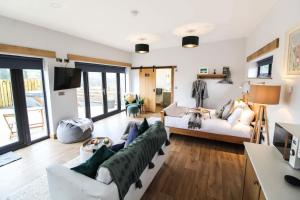 a living room with a couch and a tv at The Tin Shed in Rhayader