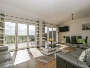 a living room with a couch and a table at Rectory Farm Lodge in Queen Camel