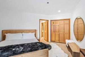 a bedroom with a bed and a mirror at Luxe Deer Valley Condo in Park City