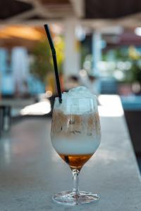 a drink with a straw in a glass on a counter at Aquata Apartments in Tivat