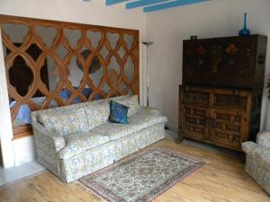 a living room with a couch and a dresser at les arbousiers in Céret