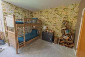a bedroom with a bunk bed and a book shelf at The Butterfly House in Malibu