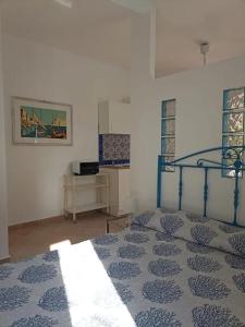 a bedroom with a blue bed and a mirror at Casa delle Sirene in Isola delle Femmine
