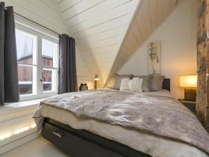 a bedroom with a large bed in front of a window at 338 - Le Quai des Veuves - Les Immeubles Charlevoix in Baie-Saint-Paul