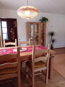 a dining room with a table and chairs and a chandelier at Ferienglück im Schwarzwald in Zimmern ob Rottweil