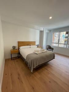 a bedroom with a bed and a wooden floor at IZARRA by Smiling Rentals in Hondarribia