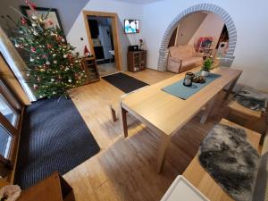 a living room with a christmas tree and a table at Chata Claudia in Zázrivá